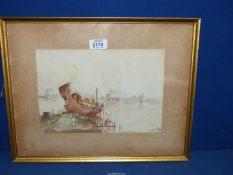 A framed Watercolour of a Junk Boat out of the water with figures and buildings in the distance,
