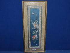 A framed embroidery.