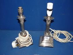 A pair of silver plated table Lamps with Corinthian columns standing on square bases,