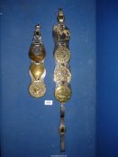 Two leather straps with a total of 7 horse brasses attached.