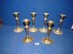 A set of six brass candlesticks, 9" tall.