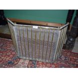 A brass and mesh three fold fire-screen/guard. 18" tall.