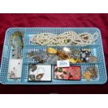 A tray of miscellaneous vintage brooches including silver, vintage beads etc.