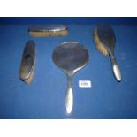A Silver backed dressing table set to include hand mirror, hair brush and two clothes brushes,