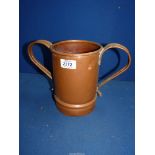 A large copper two handled mug with a small lizard to the base of the interior, 7 3/4" tall.