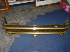 An ornately pierced Victorian brass fire fender, 41" long x 9" tall.