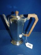 A Silver Art Deco presentation coffee Pot having wooden handle and finial, hallmarks well rubbed.