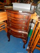 A bow fronted Mahogany Bedside Chest of four drawers on cabriole legs.