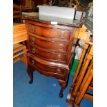 A bow fronted Mahogany Bedside Chest of four drawers on cabriole legs.