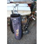 A golf bag, trolley and seven golf clubs.