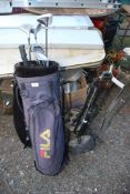 A golf bag, trolley and seven golf clubs.