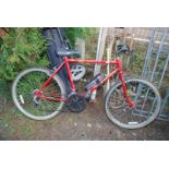 A Raleigh Scorpion bicycle, 12 gears, red/pink.