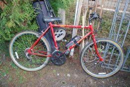 A Raleigh Scorpion bicycle, 12 gears, red/pink.