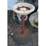 A cast iron base, 29'' high with bird bath top.