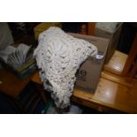 A crotchet/lace table cover.