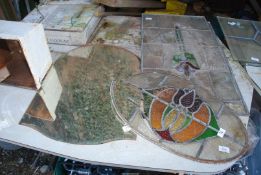 An oval section of coloured stained leaded window plus two sections of leaded stained windows,