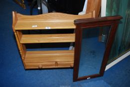 An Ercol shelf unit with drawers and mirror.