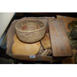 A box containing coaster/mats, stool and wicker basket.