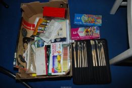 A box of pastels, paint, brushes, fat quarters etc.