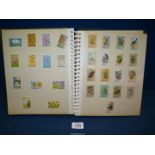 A stamp album full of Caribbean stamps.