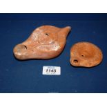 An unusual Roman red pottery oil lamp, c.