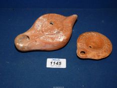 An unusual Roman red pottery oil lamp, c.