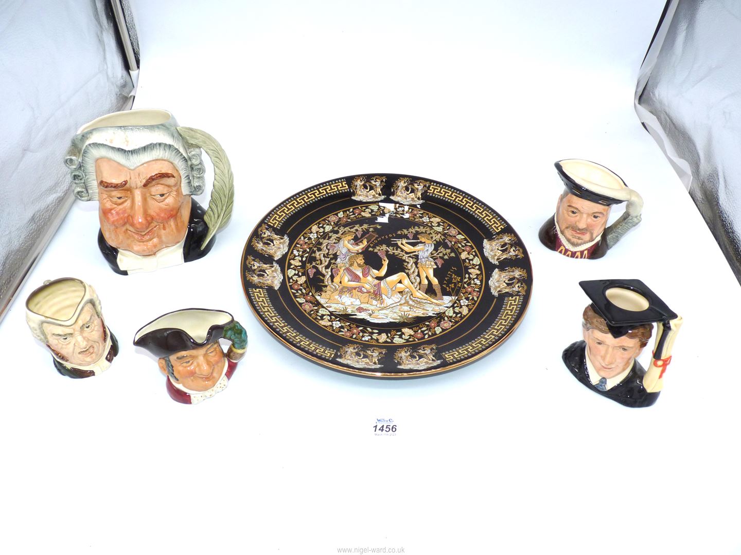 A large Royal Doulton character jug 'The Lawyer' and four smaller ones including 'Mine Host',
