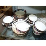A Teaset including six cups and saucers, cake plate, tea plates, milk jug and sugar bowl,