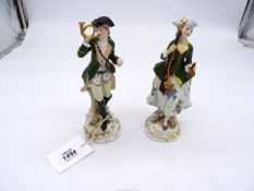 A pair of Sitzendorf porcelain figures of a Huntsman and a Lady.