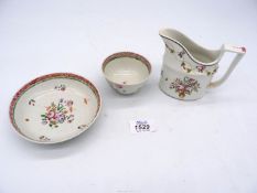 A New Hall style porcelain cream jug numbered 2 in red to base and a pearlware tea bowl and saucer.