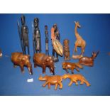 A wooden African warrior figure and animals including elephants, giraffe, etc.