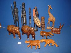 A wooden African warrior figure and animals including elephants, giraffe, etc.