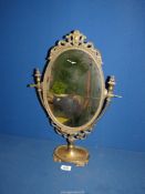 A cast metal Dressing table Mirror having scrolled detail to top, 19 1/2" tall.