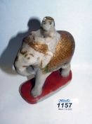 A 19th century Indian painted alabaster figure of an elephant with rider on howdah.