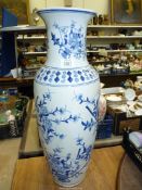 A large modern oriental floor vase with blue floral and fans design, 24'' high x 6 1/2'' diameter.