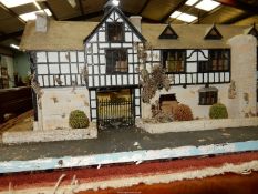 A large well detailed model of a timber framed black and white property.