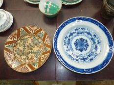 A blue Delft Charger in the Kraak style with a central floral medallion surrounded by ten radiating