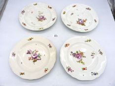 Two Vienna porcelain dinner plates, mid 18th century, painted with German flowers,