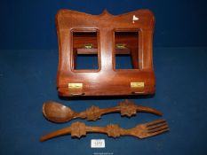 A dark wood folding Bookstand and a pair of wooden serving spoons