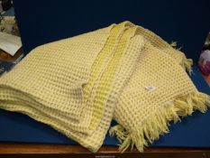 A yellow waffle weave blanket.