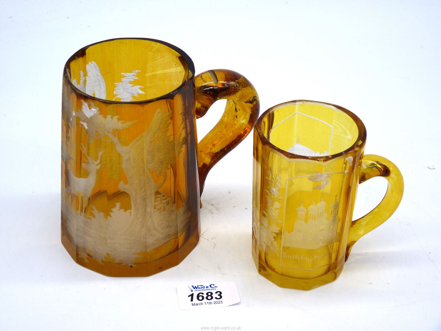 Two amber glass Tankards, the smaller one being Waisbaden, the larger one a/f.