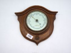 An Oak shield mounted Aneroid Barometer by W.H.