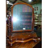 A Mahogany swing Mirror having a serpentine fluted base and twist side supports,