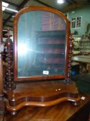 A Mahogany swing Mirror having a serpentine fluted base and twist side supports,