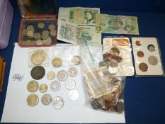 A quantity of British and foreign coins including "Britain's First Decimal Coins", three £1 notes,