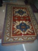 A Turkish rug in multicoloured patterns, 88'' x 58''.