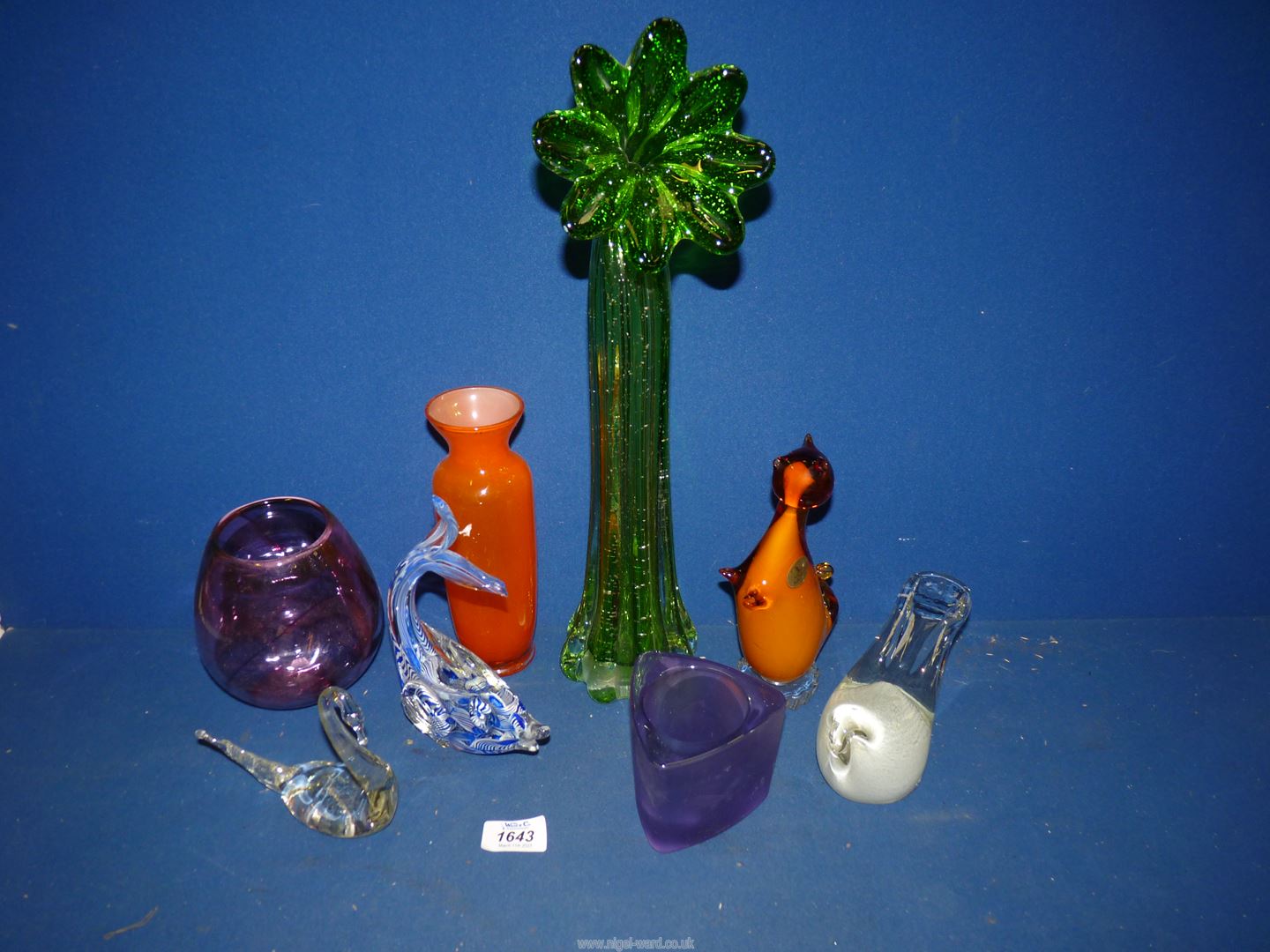 A box of coloured glass including fish, vases etc.