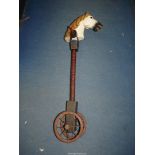 A wooden antique Hobby horse with painted head having wooden wheels with metal rims and spokes,