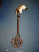 A wooden antique Hobby horse with painted head having wooden wheels with metal rims and spokes,