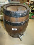 A small Oak whisky/water Barrel with metal tap, 14" tall.